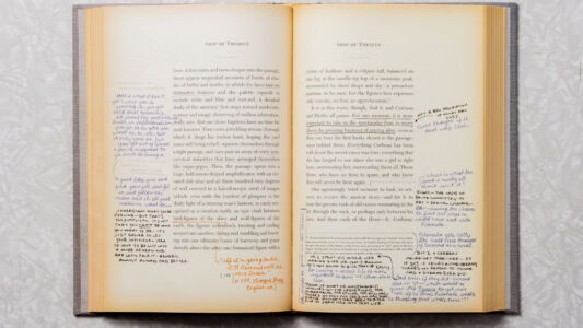 The book is a work of art.
(SHIP OF THESEUS SHIP OF THESEUS crown of feathers and a vulpine tail, balanced on there appear sequential accounts of hunts, of ritu- one leg at the needle-tip top of a mountain peak als, of births and deaths, in which the faces take on surrounded by sheer drops and skya precarious He