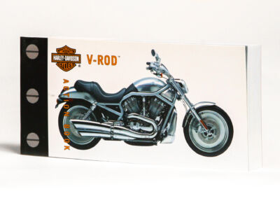 Customized motorcycle with a logo.
(MOTDR HARLEY-DAVIDSON V-ROD,bike, wheel, transportation system, vehicle, chrome, motorbike, drive, fast, tire, illustration, engine, car, brake, power, technology, no person, isolated, sport, machine, retro)
