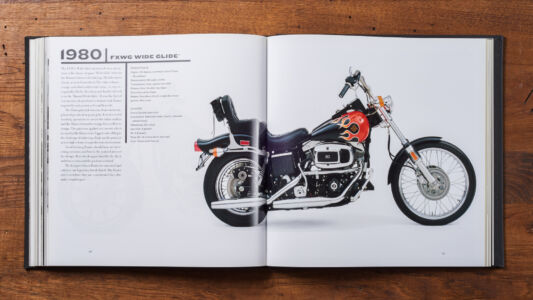 The cover of the book.
(980FXWGWIDECLIDE,bike, no person, wheel, vehicle, race, championship, competition, seated, retro, ride, action, fast, paper, biker, transportation system, indoors, one, man, technology, motorbike)