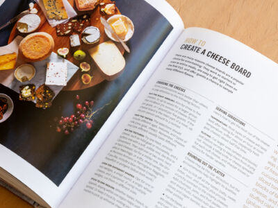 The cover of the cookbook.
(HOW TO many different flavors. CHOOSING THE CHEESES SERVING SUGGESTIONS r group (total) Ifthe goat just befc softer slicers for harder varieties at ROUNDING OUT THE PLATTER room .anda hard wa Aim to tick off all the tastes (salty. offr bitter eader cucun Add sliced t blocks of olives cheese are an and S,paper, no person, page, business, document, text, vacation, coffee, desktop, food, book bindings, wedding, data, magazine, sample, writing, still life, newspaper, drink, color)
